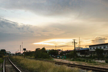Fototapeta na wymiar Railroad tracks with sunset in rural, Thailand