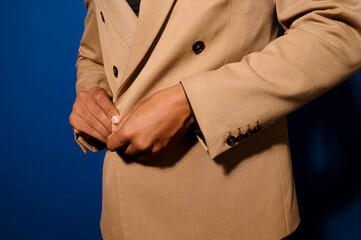Hands of guy buttoning jacket button