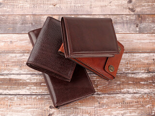 New leather multicolored wallets on wooden background