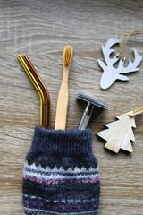 Christmas stocking filled with sustainable gifts and wooden decorations. Flat lay.