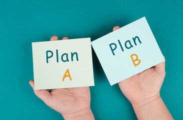 Plan A and B standing on paper, options of possibilities, making a decision