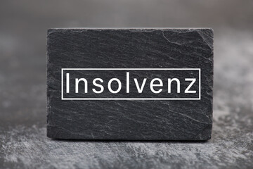 The word insolvency is standing in german language on a sign, bankrupt through lockdown, pandemic...