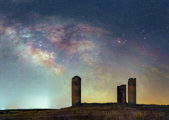 Antique castle towers with galatic center in starry night
