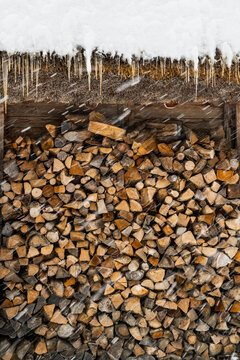 fire wood stacked outside of a traditional house in Japan