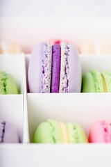 Box with purple and green sweet macarons, copy space