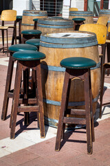 chairs and tables in the form of barrels in a street cafe