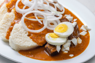 beef goulash with onion rings, boiled egg and dumplings