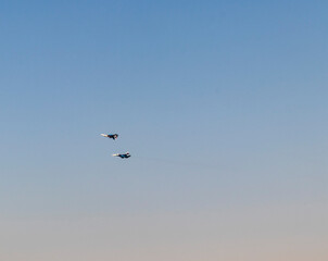 Military airplanes performing stunts in clear blue sky. Airshow