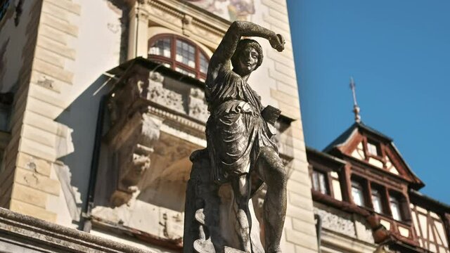 Vertical view of a sculpture at The Peles Castle in Romania. Castle on the background