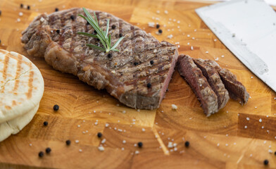 beef steak on wooden chopping board