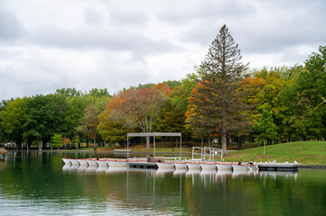 boats at the pier on the lake in the city park
