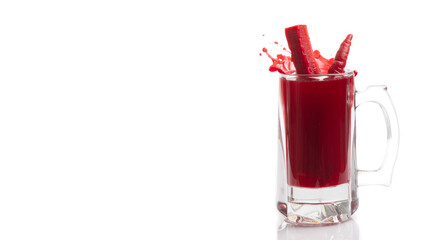 Glass of turnip juice with carrot on white background