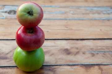 Red and green apples lie vertically on top of each other. High quality photo
