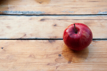 One apple on a wooden table close-up. High quality photo