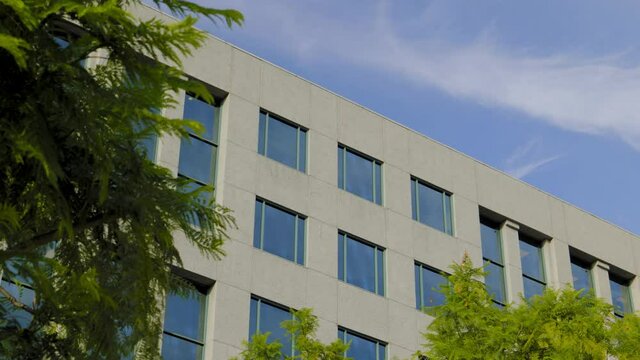 MODEST, MODERN OFFICE BUILDING ESTABLISHING SHOT.  4K LOCK OFF.  NO PEOPLE.