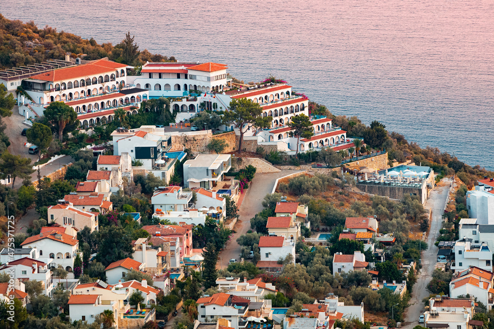 Wall mural sunset aerial view of seashore resort town on mediterranean coast. romantic harbour and villas with 