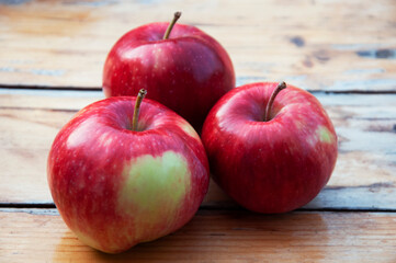 In the foreground are three apples with a green heart on the side. High quality photo