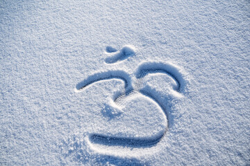 The sign is written in the snow. Om shanti. The symbol of yoga represents ancient knowledge,...