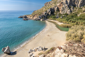 Stunning Preveli Beach, a secluded white sand beach surrounded by palm groves at the end of a gorge...