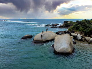 Sand beach among rocks on evening sunset. La piscina beach in National park Tayrona, Colombia