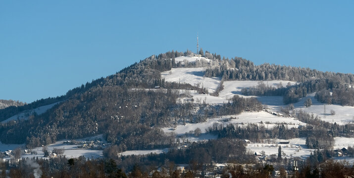 View of the snow-capped bachtel summit (Bachtel Kulm, Z&uuml;rcher Oberland), from Rapperswil-Jona, St. Gallen, Switzerland