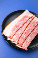 slices bacon fresh belly pork meat piece of meat layer lard fat healthy meal food diet snack on the table copy space food background rustic