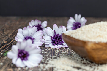 Fototapeta na wymiar white sesame seeds on a wooden table