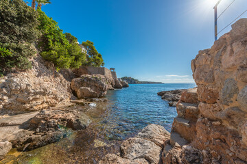 Fototapeta na wymiar Majorcan coastal area of rocks with calm sea and blue sky