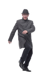 Naklejka premium cheerful man in a hat and autumn coat striding forward .