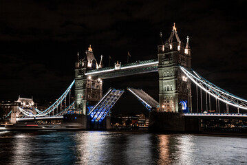 London Tower Bridge lifting up at night.