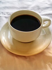 black coffee in ceramic cup on wooden table