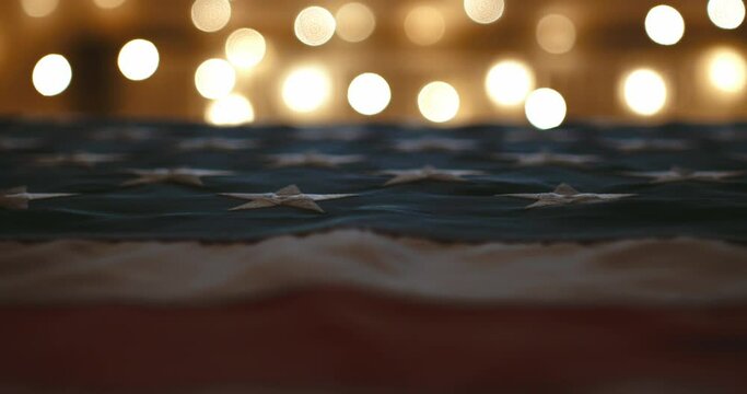 cinematic camera flyby near american flag with luxurious and beautiful bokeh in the background