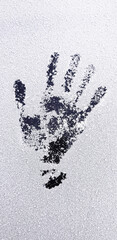 Handprint in the snow. The effect of human heat on snow. Hand print in snow