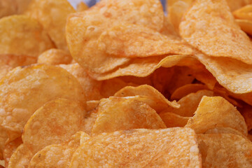 Potato chips or crisps . Close-up of potato chips or crisps. Food background.