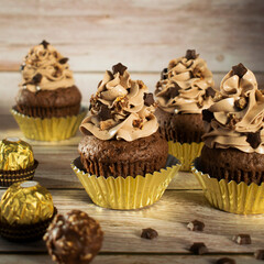 Ferrero Rocher Christmas chocolate cupcakes. Muffins with chocolate cream.