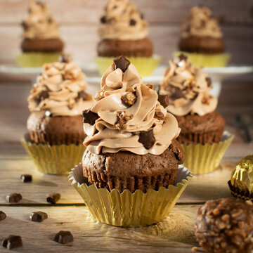 Ferrero Rocher Christmas chocolate cupcakes. Muffins with chocolate cream.