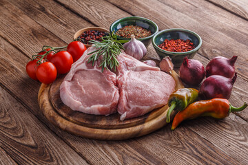fresh raw new-york steak on wooden Board on wooden background with salt and pepper in a rustic style.