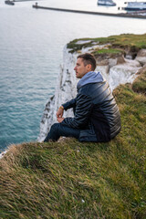 Fototapeta na wymiar Young man exploring the White Cliffs of Dover in UK.