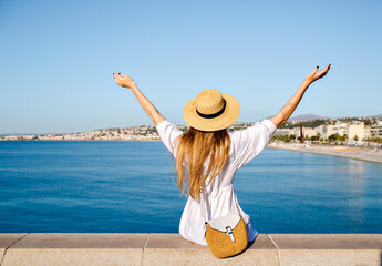Outdoor traveling portrait of pretty cheerful young tourist woman