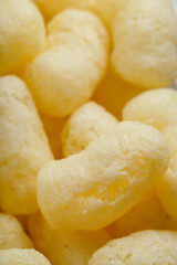 Corn sticks in powdered sugar as a texture, crispy sweets