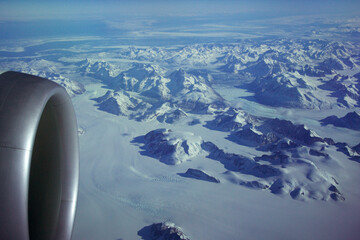 GREENLAND - 10 MAY 2018: View from the aircraft window of the engine of a Boeing 787 over the icebergs of Greenland