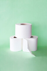 set of toilet paper on green background. close up