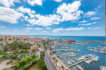 High views of the Molinar port in Palma de Mallorca and a park with trees. Blue sky