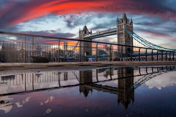 Iconic Tower Bridge view connecting London with Southwark over Thames River, UK. Beautiful view of the bridge during magical orange sunset over the city.