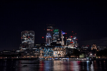 Fototapeta na wymiar Panoramic view of the London financial district with many skyscrapers in the center of London at night. 