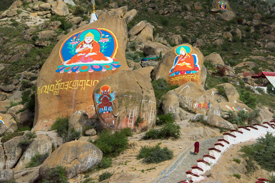 Image of Buddha painted on rock, Drepung Monastery, one of the great three Gelug university monasteries of Tibet, Lhasa, Tibet, China