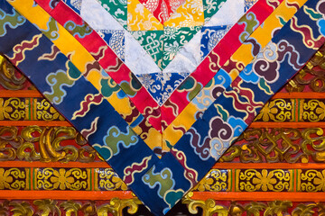 Buddhist flag with architectural details in Drepung Monastery, one of the great three Gelug university monasteries of Tibet, Lhasa, Tibet, China