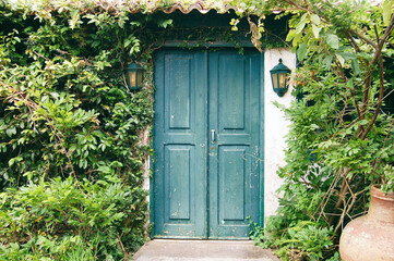 Fototapeta na wymiar Old turquoise door and lanterns