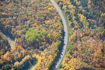 Aerial view of curving road in northern Minnesota on a sunny autumn day