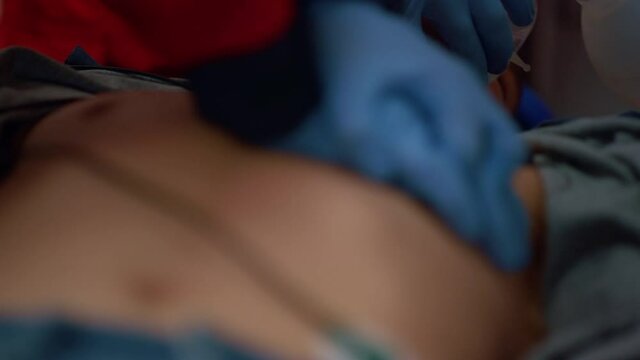 Paramedics hands providing cardiac massage on chest of patient